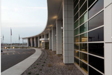 The predetermined location and orientation of the building posed a thermal problem... The solution became the centerpiece of the project's daylight-harvesting strategy. Gray installed a 4,900-sq.-ft SageGlass® electrochromic (electronically tintable) glass wall on the west façade of the office building, which is tied to the building energy management system and automatically tints based on sunlight and measured solar heat gain.